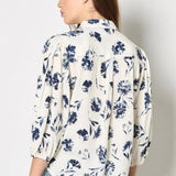 Add feminine florals to your weekly rotation with this pressed daisy print shirt. Designed in a soft, woven fabric, it features a collar, a button-down front, and cropped balloon sleeves. Keep this floral shirt casual with light-wash denim, or style it with tailored trousers and loafers for an office to off-duty look.
