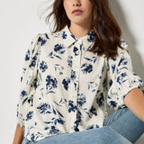 Add feminine florals to your weekly rotation with this pressed daisy print shirt. Designed in a soft, woven fabric, it features a collar, a button-down front, and cropped balloon sleeves. Keep this floral shirt casual with light-wash denim, or style it with tailored trousers and loafers for an office to off-duty look.
