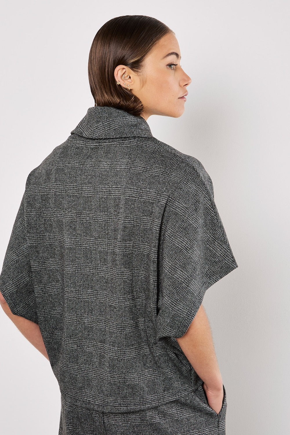 Experience timeless elegance with our Apricot Prince Of Wales Cowl Neck Batwing Top. Made with a classic black and grey check, this top is versatile and perfect for any occasion. Elevate your style with a touch of sophistication.