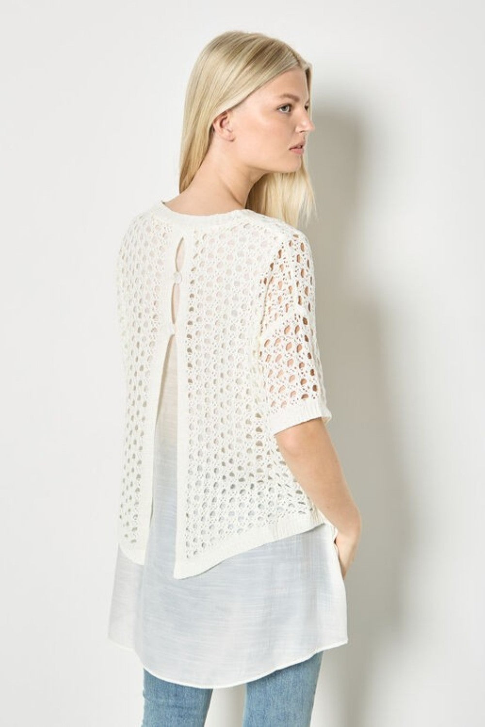 Elevate your wardrobe with this layered tunic top. With knitted mesh and woven layers designed to create a soft, relaxed fit, it boasts a button-down back, a curved hem, and a shimmering finish. Style with slim-fit trousers when the weekend arrives, or create a feminine, free-flowing silhouette with a tiered maxi skirt for a boho chic look.