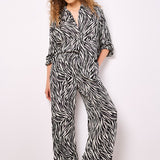 Lightweight, woven and textured, these wide-leg trousers are designed to create a fluid silhouette. Boasting a bold zebra print, they feature an elastic panel at the waist for a comfortable fit, a hook and zip fastening, plus practical pockets.