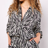 Lightweight, woven and textured, these wide-leg trousers are designed to create a fluid silhouette. Boasting a bold zebra print, they feature an elastic panel at the waist for a comfortable fit, a hook and zip fastening, plus practical pockets.