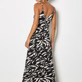 Woman wearing a zebra print dress against a white background