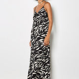 Woman wearing a zebra print dress against a white background