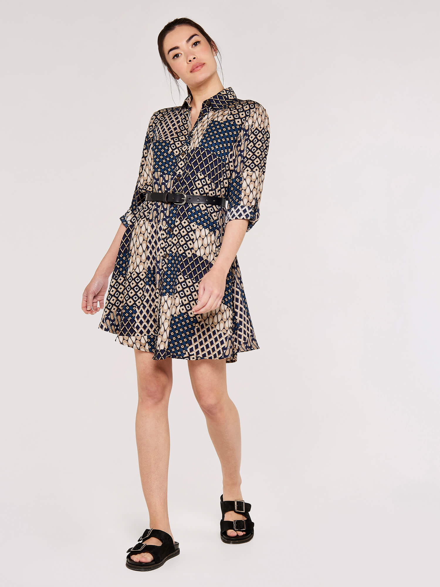 Make a statement with the Apricot Patchwork Swing Shirt Dress. This dress features an eye-catching patchwork pattern and a swing silhoue