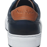 This navy blue leather sneaker features a sleek design complemented by stylish white trim, making it a versatile addition to any wardrobe. Made from high-quality materials, it offers both durability and comfort, ideal for casual outings or everyday wear. The combination of classic black and crisp white ensures a modern aesthetic, while the sneaker's lightweight construction offers ease of movement. Perfect for those seeking a blend of fashion and functionality.