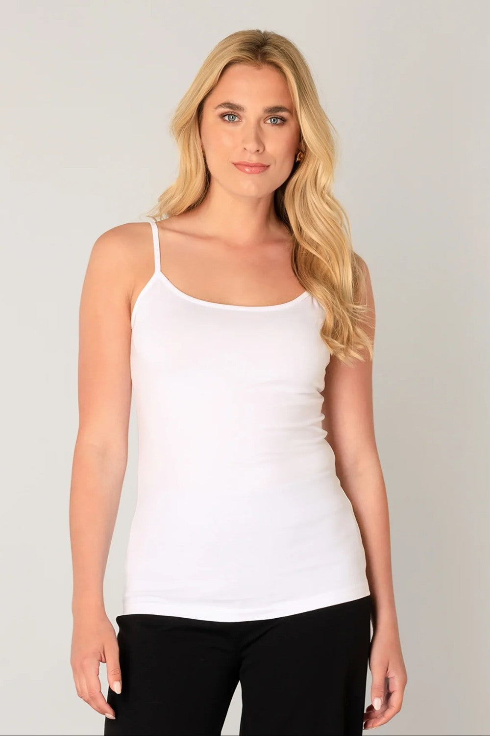 White tank top with black pants on light background.
