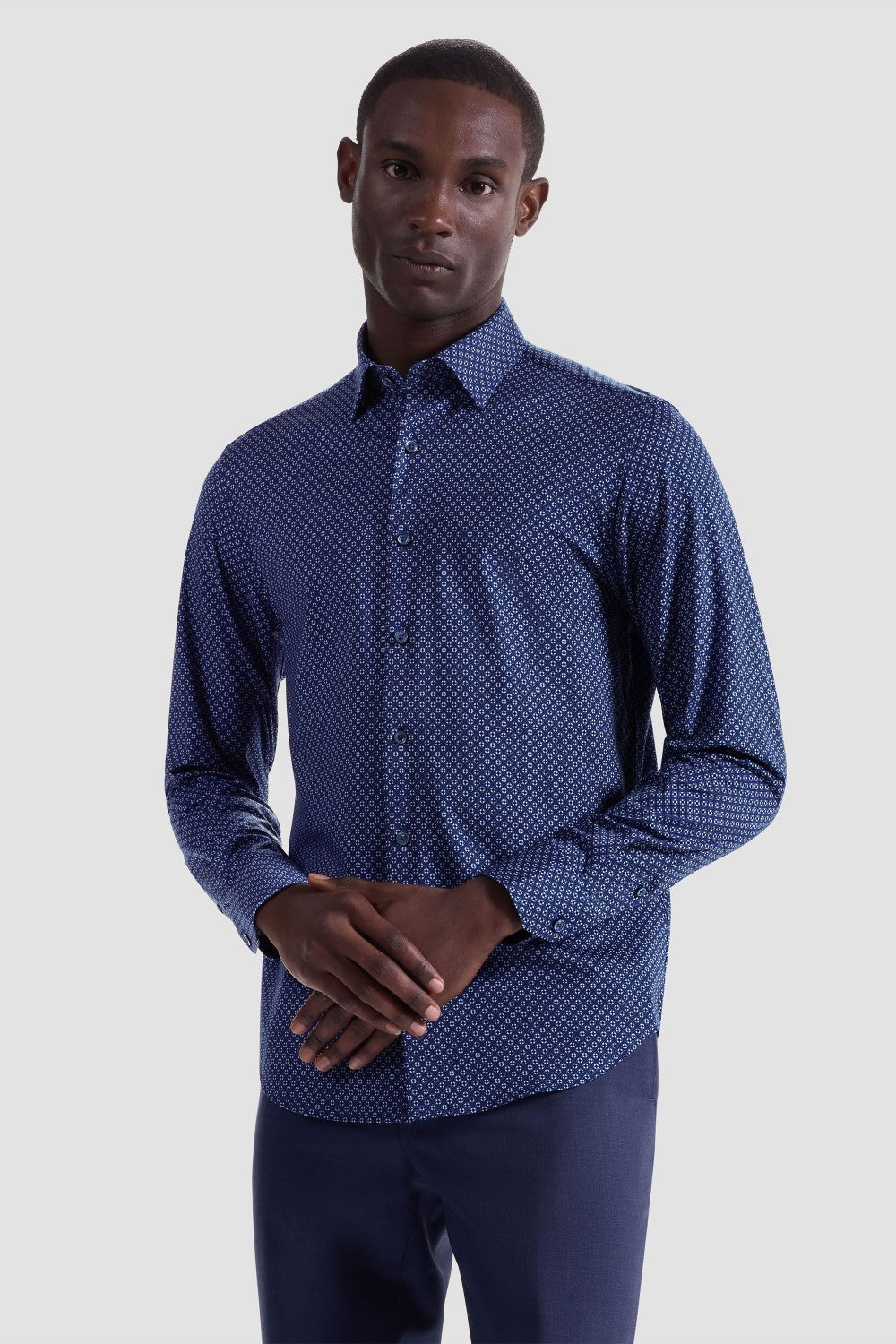 The Jules OoohCotton long-sleeved shirt in geometric print features a hidden button-down collar, mother-of-pearl buttons, and a curved hem for a sleek tucked or untucked look. The notched cuffs are adjustable to allow for customized fit and also convertible to accommodate cufflinks. OoohCotton® is a performance, double-mercerized, wrinkle-resistant, breathable, and easy-care cotton blend with 8-way stretch, quick-dry, and thermal comfort properties.