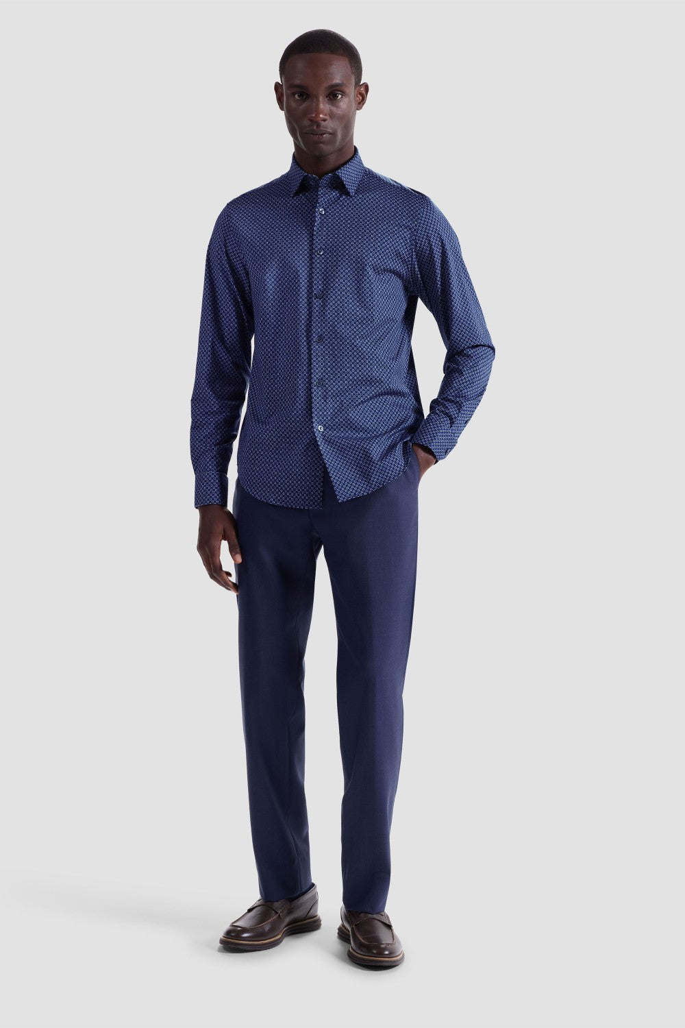 The Jules OoohCotton long-sleeved shirt in geometric print features a hidden button-down collar, mother-of-pearl buttons, and a curved hem for a sleek tucked or untucked look. The notched cuffs are adjustable to allow for customized fit and also convertible to accommodate cufflinks. OoohCotton® is a performance, double-mercerized, wrinkle-resistant, breathable, and easy-care cotton blend with 8-way stretch, quick-dry, and thermal comfort properties.