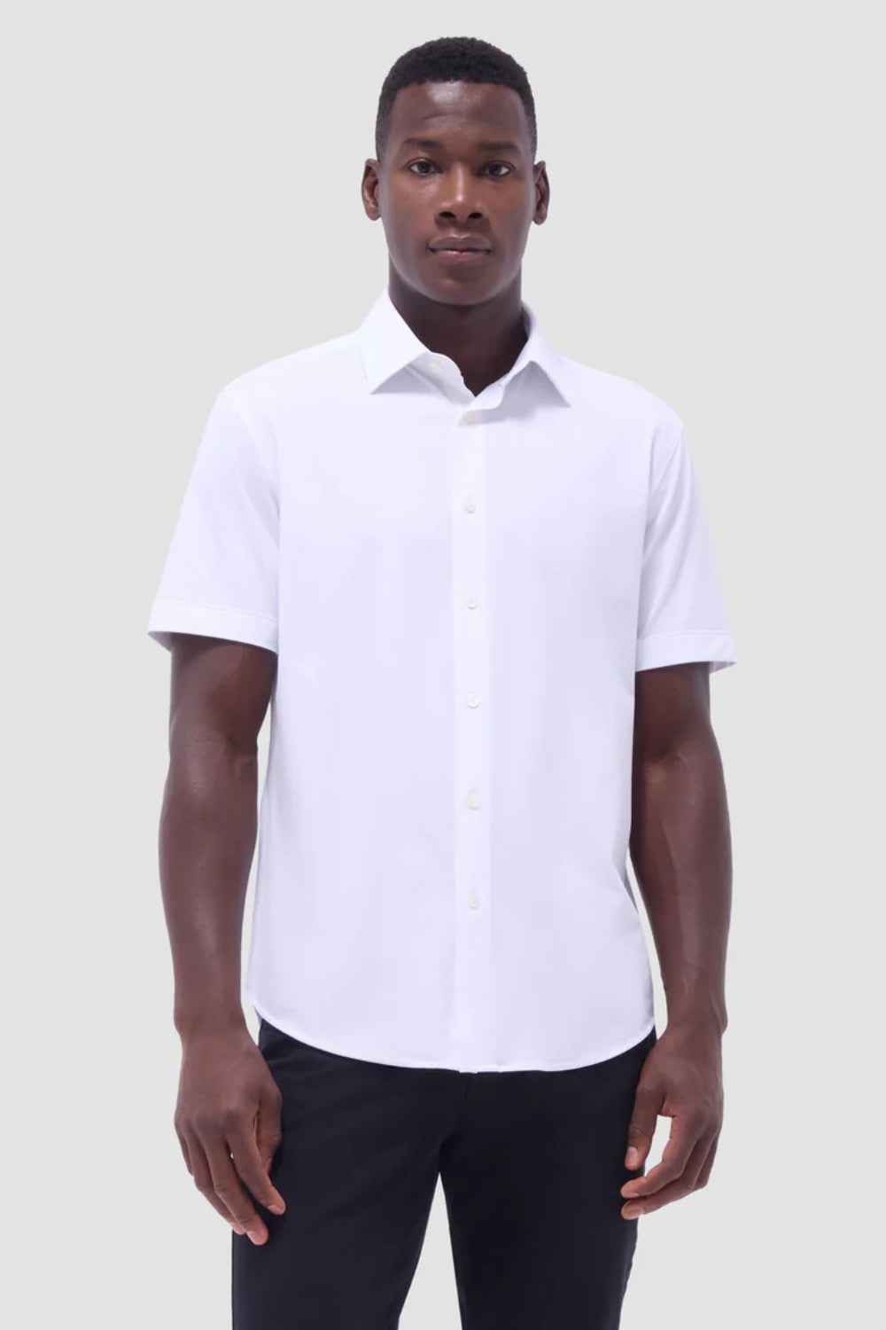 The Miles solid OoohCOtton short-sleeved shirt features a point collar, mother-of-pearl buttons, and a curved hem perfect for wearing tucked or untucked. OoohCOtton is a performance, double-mercerized, wrinkle-resistant, breathable, and easy-care cOtton blend with 8-way stretch, quick-dry, and thermal comfort properties.