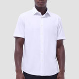 The Miles solid OoohCOtton short-sleeved shirt features a point collar, mother-of-pearl buttons, and a curved hem perfect for wearing tucked or untucked. OoohCOtton is a performance, double-mercerized, wrinkle-resistant, breathable, and easy-care cOtton blend with 8-way stretch, quick-dry, and thermal comfort properties.