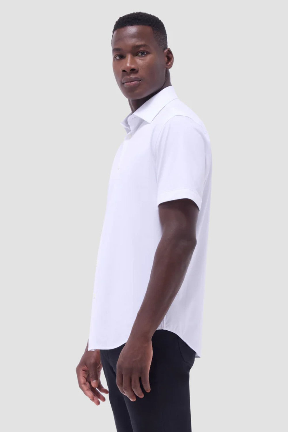 The Miles solid OoohCOtton short-sleeved shirt features a point collar, mother-of-pearl buttons, and a curved hem perfect for wearing tucked or untucked. OoohCOtton is a performance, double-mercerized, wrinkle-resistant, breathable, and easy-care cOtton blend with 8-way stretch, quick-dry, and thermal comfort properties.