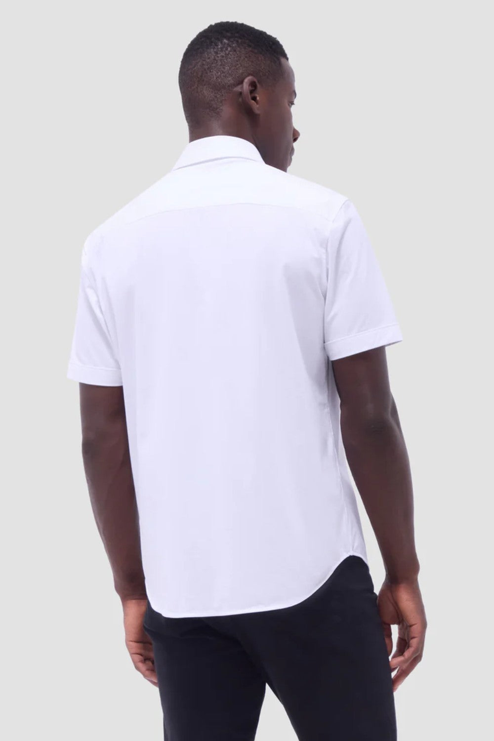 The Miles solid OoohCOtton short-sleeved shirt features a point collar, mother-of-pearl buttons, and a curved hem perfect for wearing tucked or untucked. OoohCOtton is a performance, double-mercerized, wrinkle-resistant, breathable, and easy-care cOtton blend with 8-way stretch, quick-dry, and thermal comfort properties.