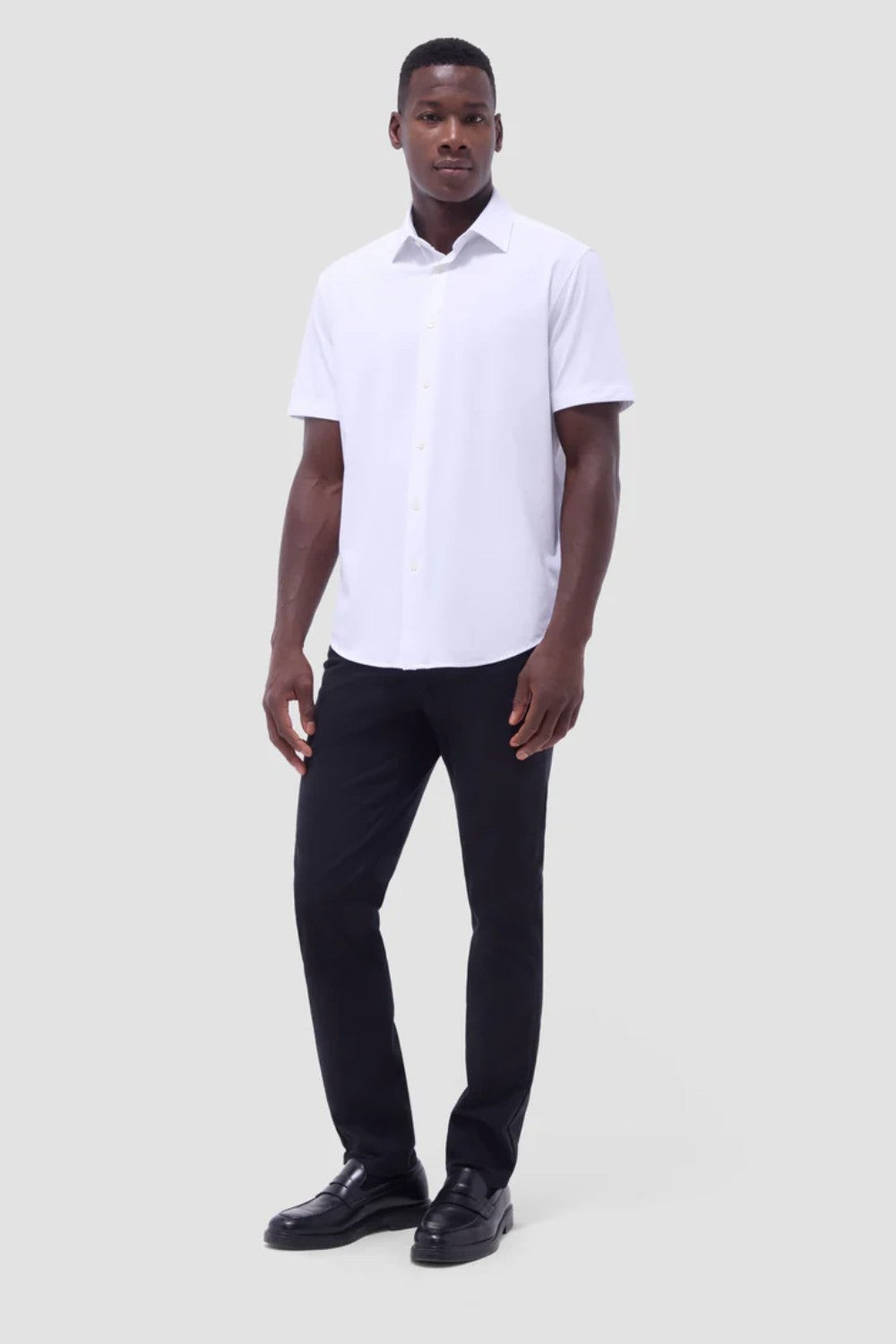 The Miles solid OoohCOtton short-sleeved shirt features a point collar, mother-of-pearl buttons, and a curved hem perfect for wearing tucked or untucked. OoohCOtton is a performance, double-mercerized, wrinkle-resistant, breathable, and easy-care cOtton blend with 8-way stretch, quick-dry, and thermal comfort properties.