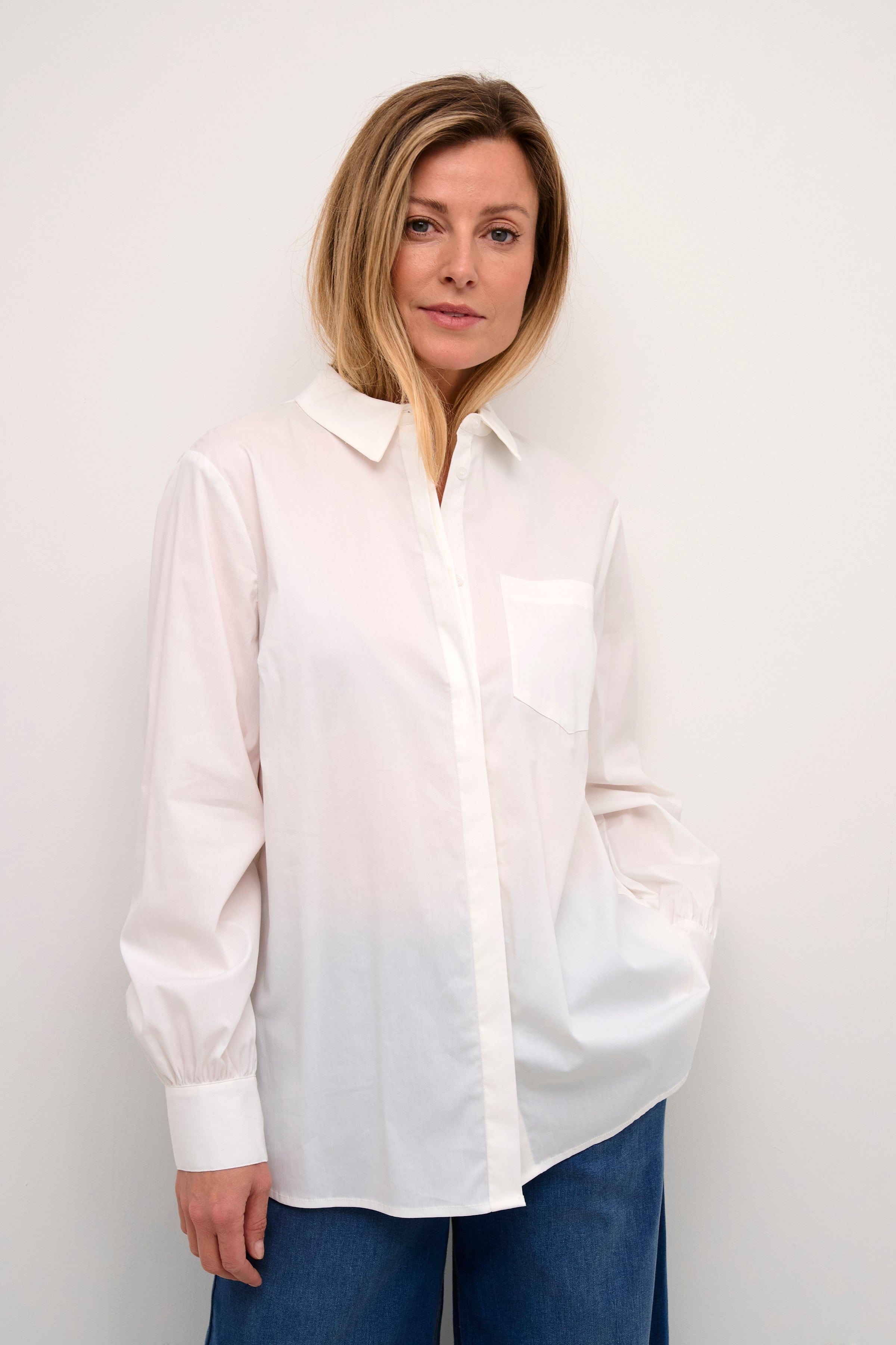 This Cream Acca Shirt combines the timeless look of a classic white shirt with a touch of elegance. The front is sleek and professional while the back features delicate lace detail, adding a feminine touch. Perfect for any occasion, this shirt is versatile and stylish.