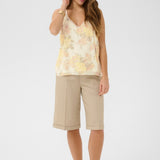 The Cream Alitia Top features a soft, romantic aesthetic with a pretty floral pattern throughout. 