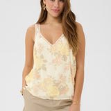 The Cream Alitia Top features a soft, romantic aesthetic with a pretty floral pattern throughout. 