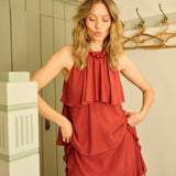 Woman wearing a red dress in a hallway setting