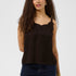 Woman wearing a brown sleeveless top with lace details and blue jeans on a white background