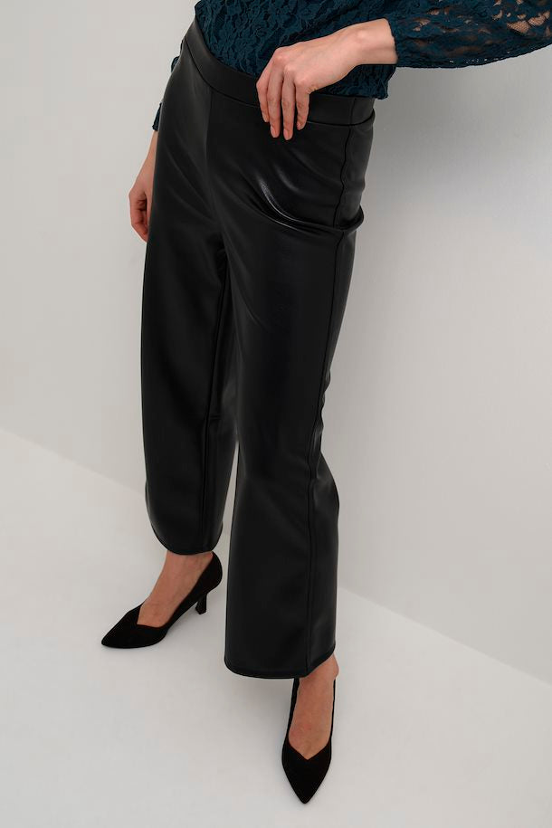 Step into chic style with these Cream Ariana 7/8 Trousers. Crafted from faux leather with a slip-on design, they feature a wide-leg cut that's perfect for a cool and timeless look. 