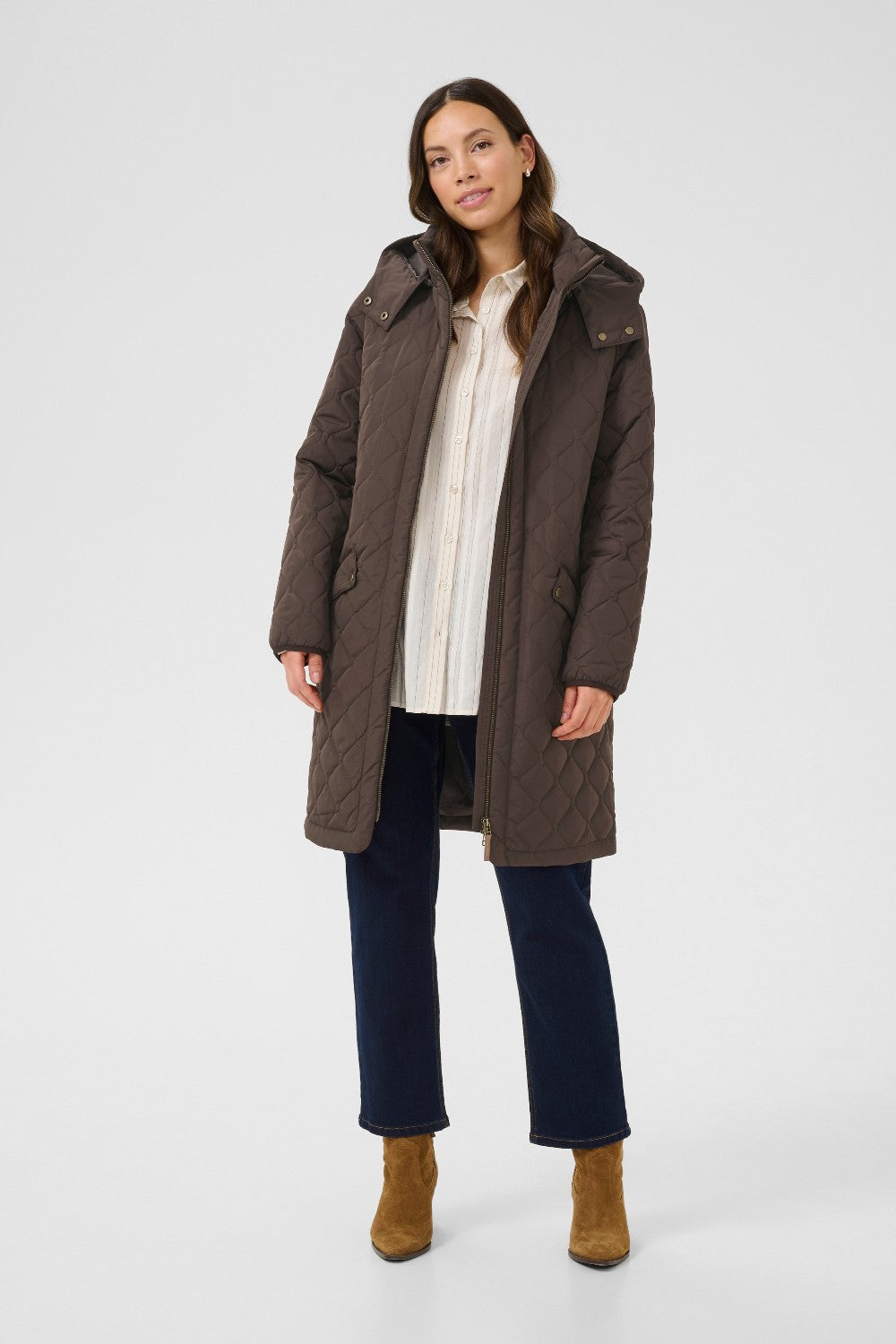 Woman wearing a brown coat on a white background