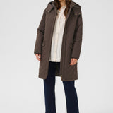 Woman wearing a brown coat on a white background