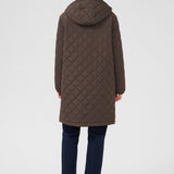 Person wearing a brown quilted coat on a white background