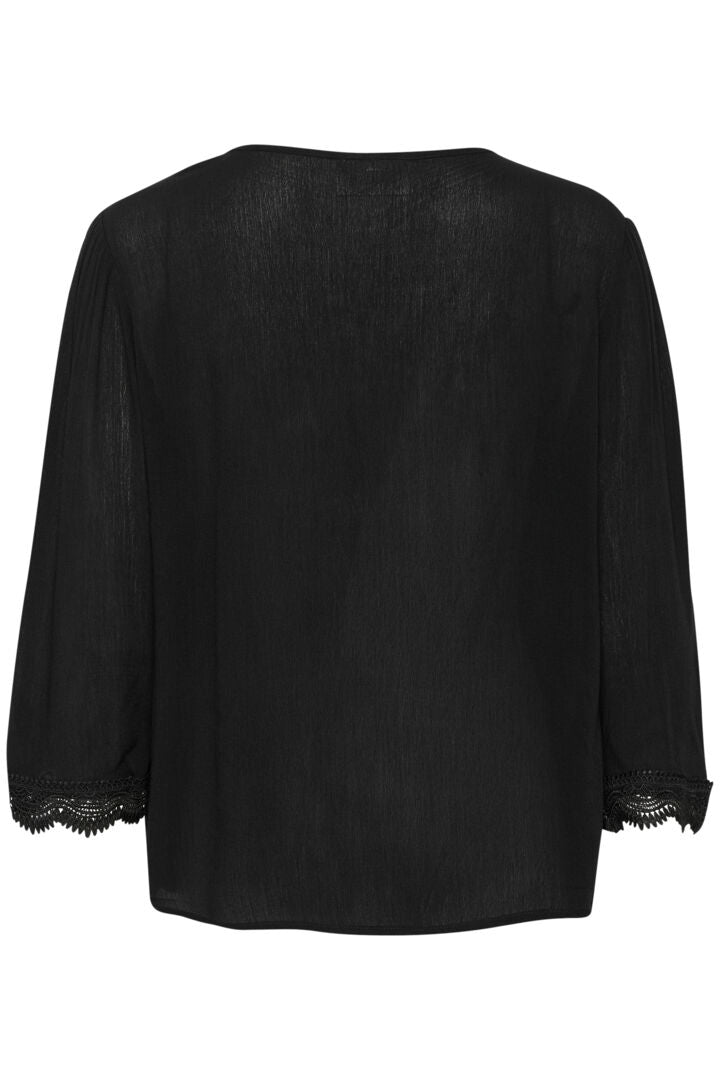 The Cream Bea 3/4 Sleeve Lace Blouse features a sleek black colour and a charming front tie with tassels. Elevate any outfit with this versatile piece, perfect for adding a touch of sophistication to your wardrobe.