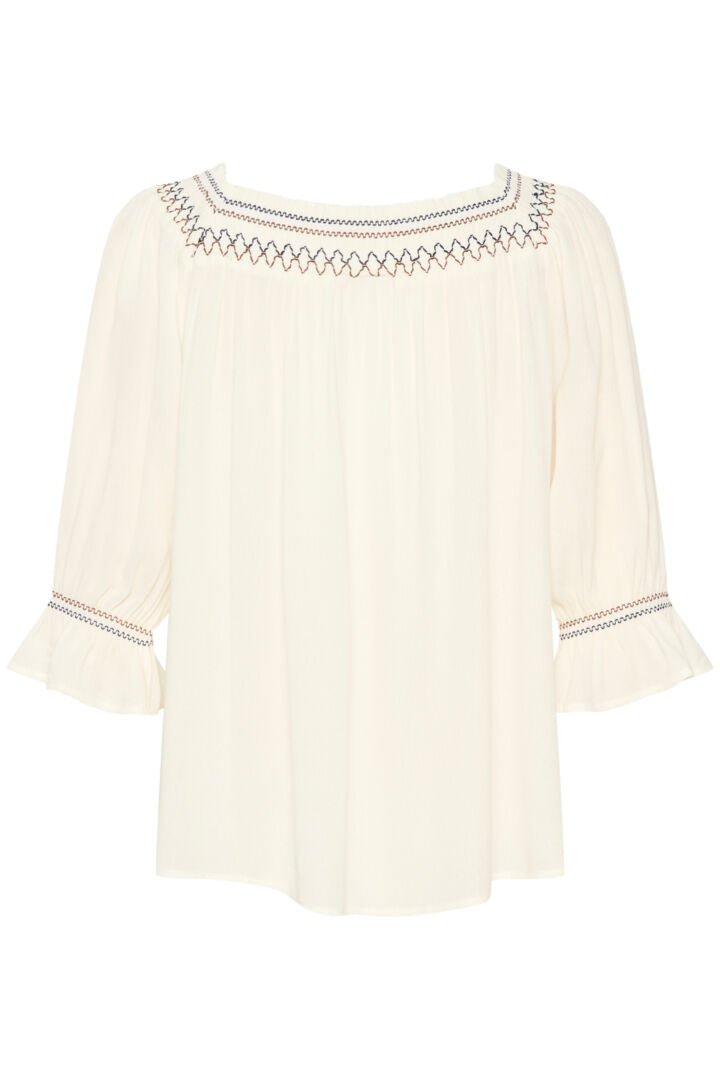 This Cream Bea Smock Blouse features a beautiful off-white colour with intricate black and brown embroidery on the neck and sleeves. With a delicate smocked design, this blouse exudes elegance and style. Perfect for any occasion, it is a must-have addition to any wardrobe.