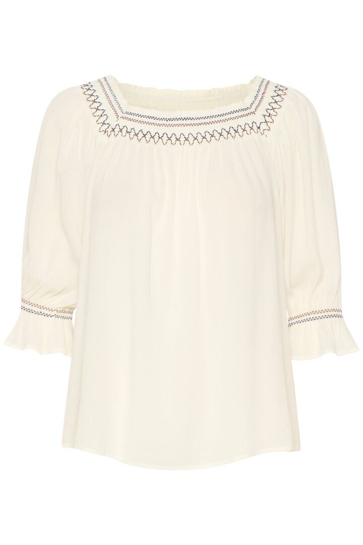 This Cream Bea Smock Blouse features a beautiful off-white colour with intricate black and brown embroidery on the neck and sleeves. With a delicate smocked design, this blouse exudes elegance and style. Perfect for any occasion, it is a must-have addition to any wardrobe.