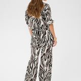 Woman wearing a zebra print outfit on a white background