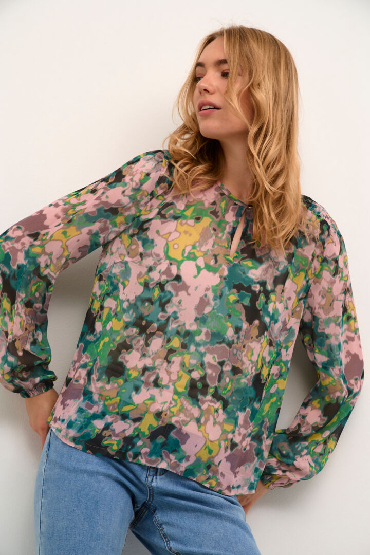 The Cream Birgitta Blouse features a multi-colour print that adds a touch of boldness to any outfit. The built-in, removable cami provides both comfort and versatility. The keyhole neckline, complete with a small button closure, adds a subtle yet elegant touch to this stylish blouse.