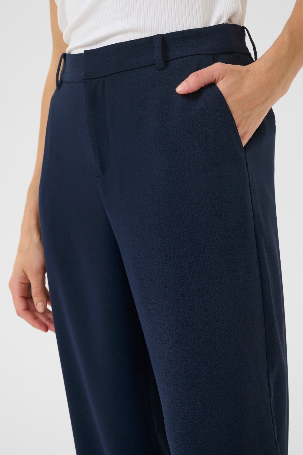 The Cream Cocamia Pant is a versatile and stylish addition to any wardrobe. This pant offers a sleek and sophisticated look, and the zip and button closure, along with the elastic back waist, provide a comfortable fit for all-day wear. Complete with pockets and belt loops, this pant offers both style and functionality.