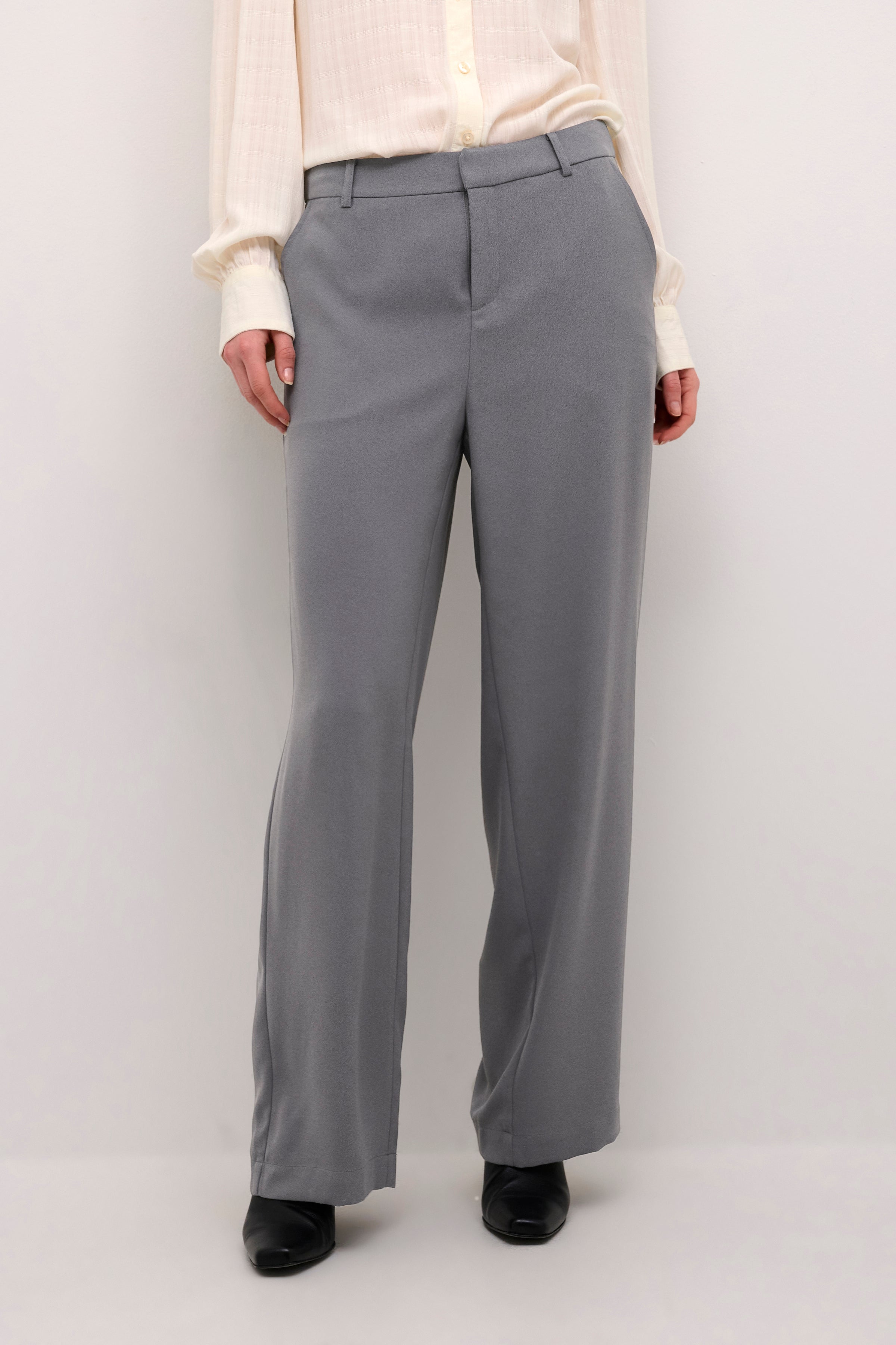 The Cream Cocamia Pant is a versatile and stylish addition to any wardrobe. This pant offers a sleek and sophisticated look, and the zip and button closure, along with the elastic back waist, provide a comfortable fit for all-day wear. Complete with pockets and belt loops, this pant offers both style and functionality.