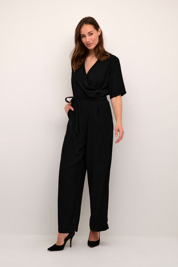 Revamp your wardrobe with this ultra chic Cream Cocamia Jumpsuit! Featuring a pitch black finish, this modern take on a classic jumpsuit