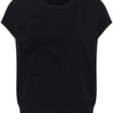Black t-shirt with a flower design on a white background