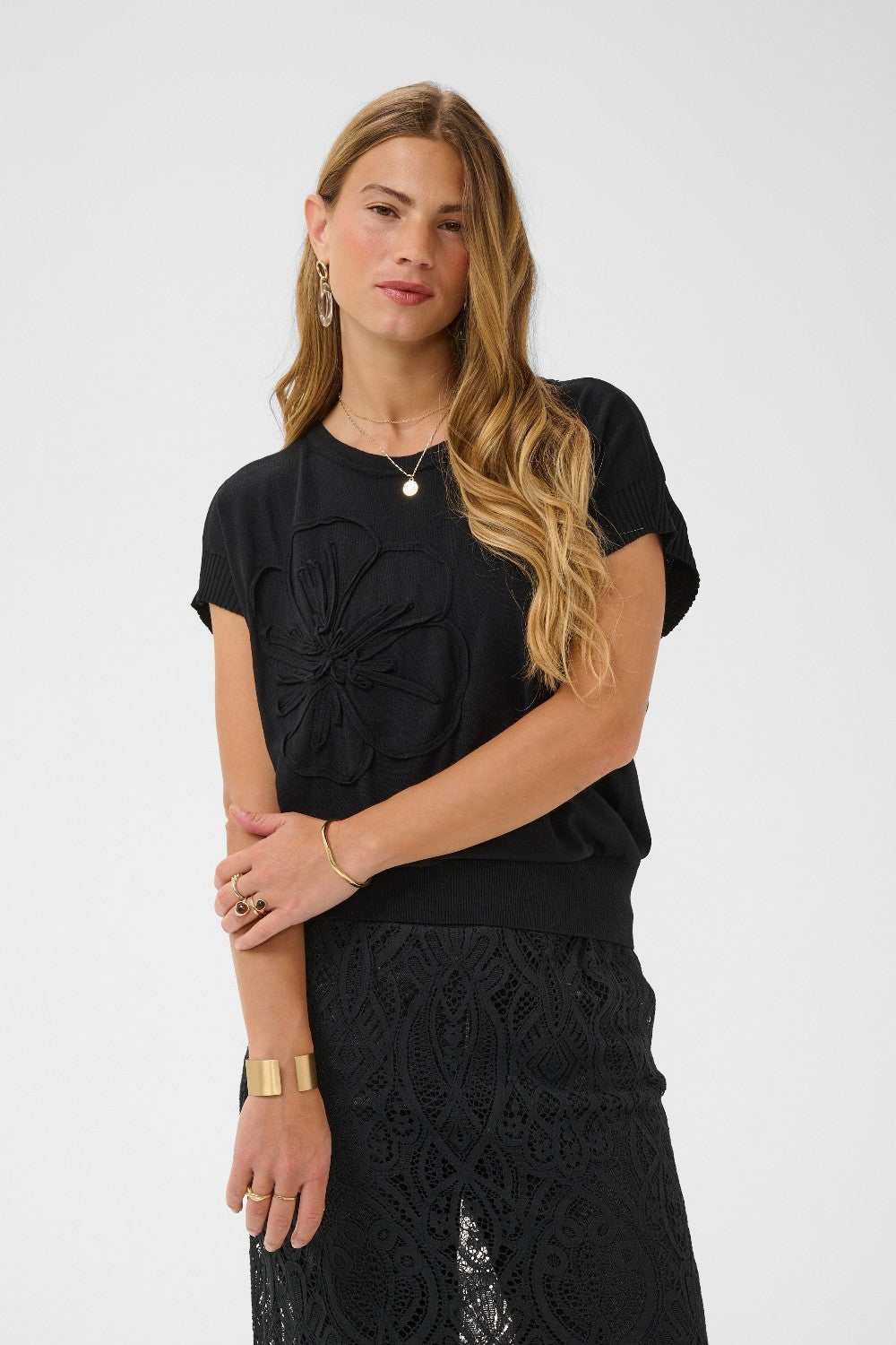 Woman wearing a black outfit with a white background