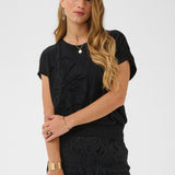 Woman wearing a black outfit with a white background