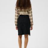 Person wearing a plaid shirt and black skirt from behind on a white background