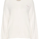 Experience ultimate comfort and style with our Cream Frosty Knit Pullover. Crafted from a soft, cosy fabric, this pullover will keep you warm and comfortable all day long. The adorable removable pin add a touch of elegance to this versatile piece. Perfect for any occasion, it's a must-have addition to your wardrobe.