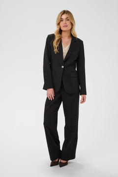 Woman wearing a black suit on a white background