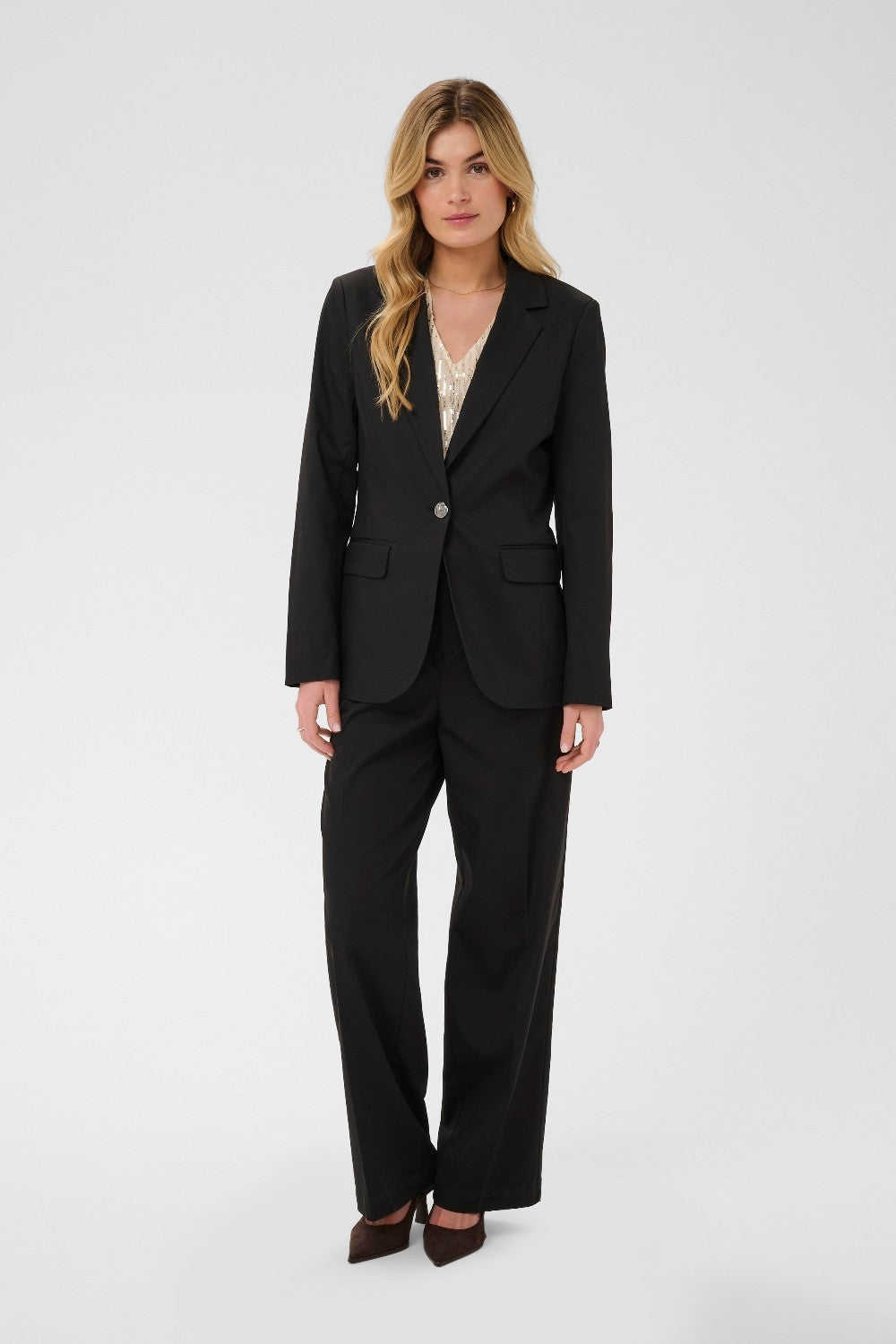 Woman wearing a black suit on a white background