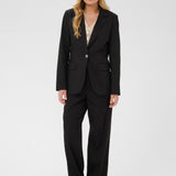 Woman wearing a black suit on a white background
