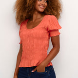 Make a statement with the Cream Henva O-Neck Blouse. This versatile blouse features short sleeves and a flattering O-neck design, perfect for any occasion. The hot coral colour adds a pop of vibrancy to any outfit. Elevate your style and feel confident in this must-have wardrobe essential.  Fit: Easy fit Length: Hip length Length: 55 cm corresponds to size 34 Composition : 55% Viscose (LENZING™ ECOVERO™), 45% Viscose