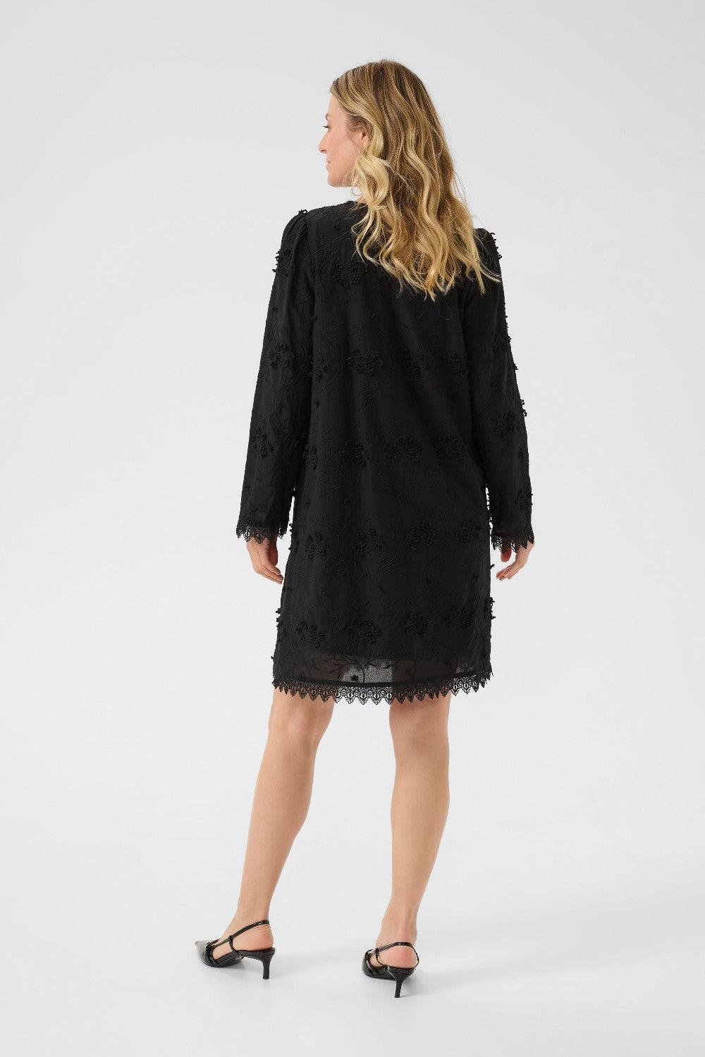 Woman wearing a black dress on a white background