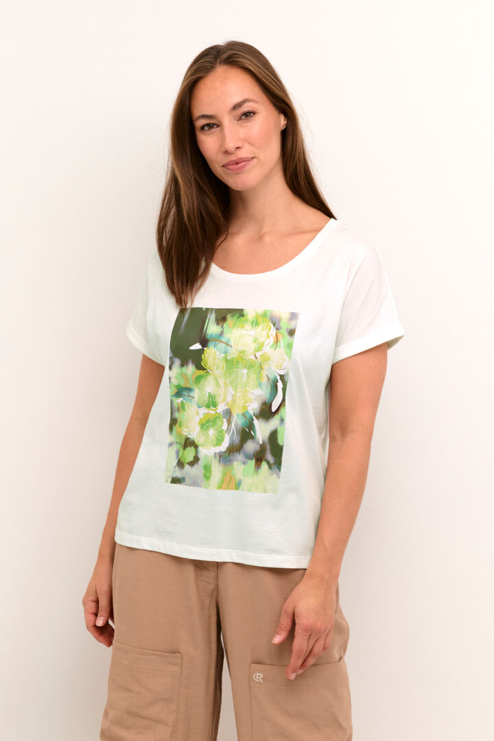 Stay cool and stylish with our Cream Irma T-Shirt. Made from 100% cotton, this tee features a vibrant green flower print. Perfect for any casual occasion, this shirt will become a staple in your wardrobe. (Seriously, it's a must-have!)
