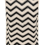 Black and white zigzag patterned vest with decorative elements on a white background