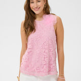 Woman wearing a pink lace top against a white background