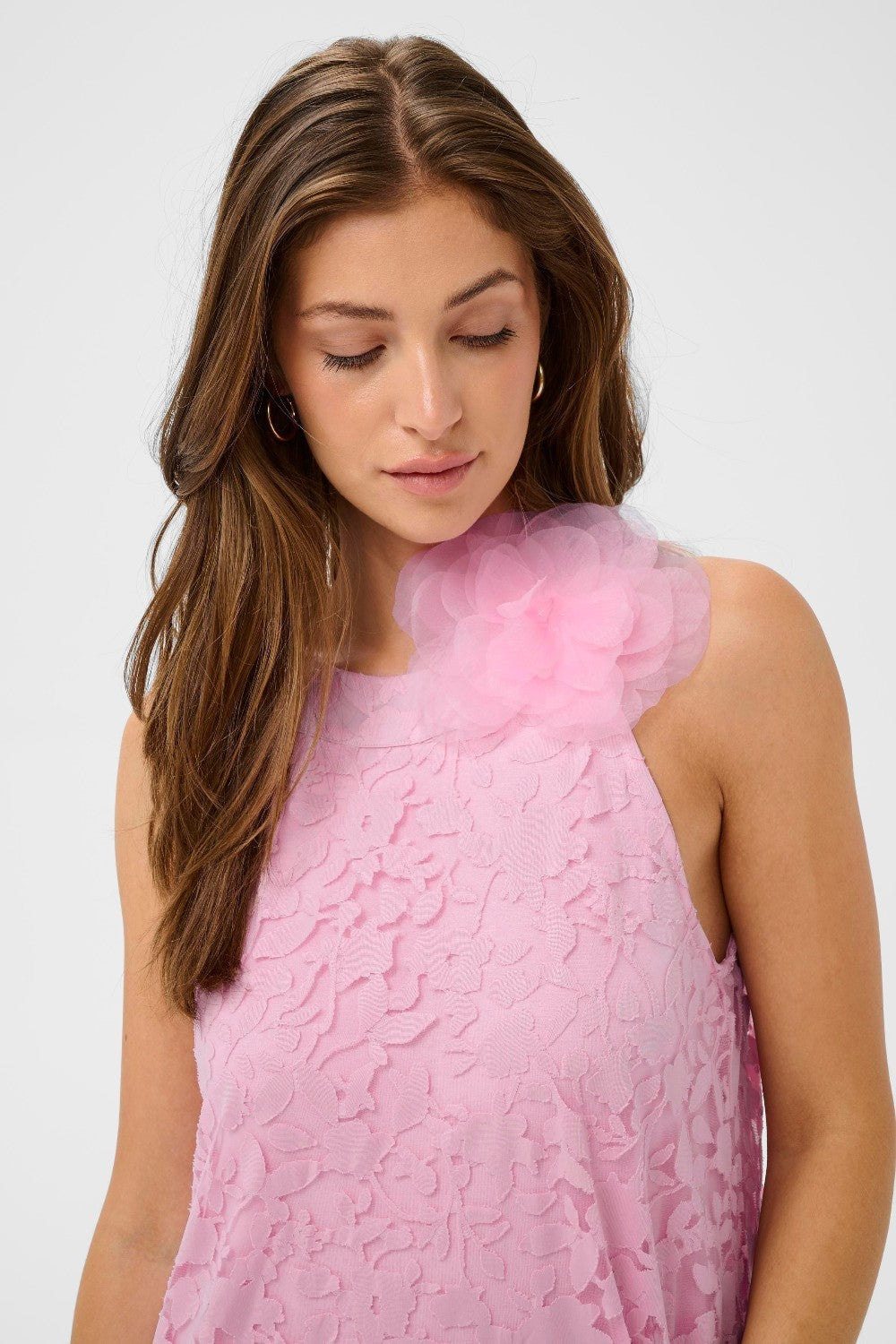 Woman wearing a pink dress against a white background