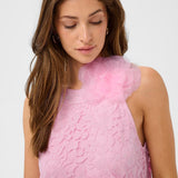 Woman wearing a pink dress against a white background